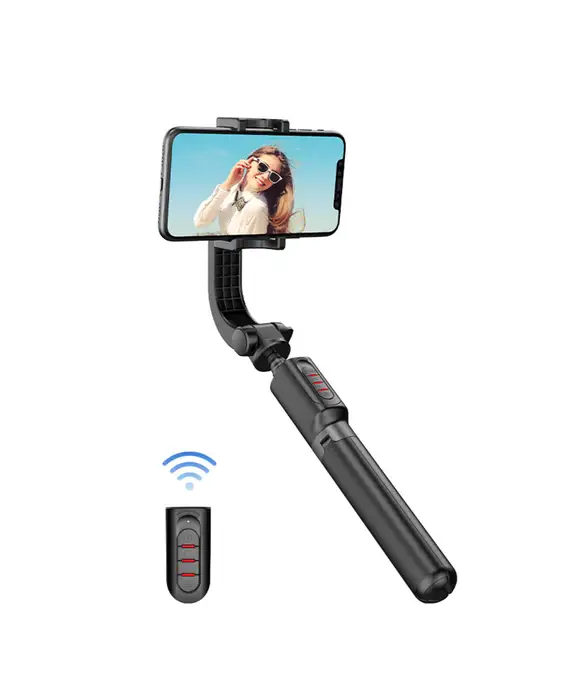 A phone is being held up by the handle of a selfie stick.