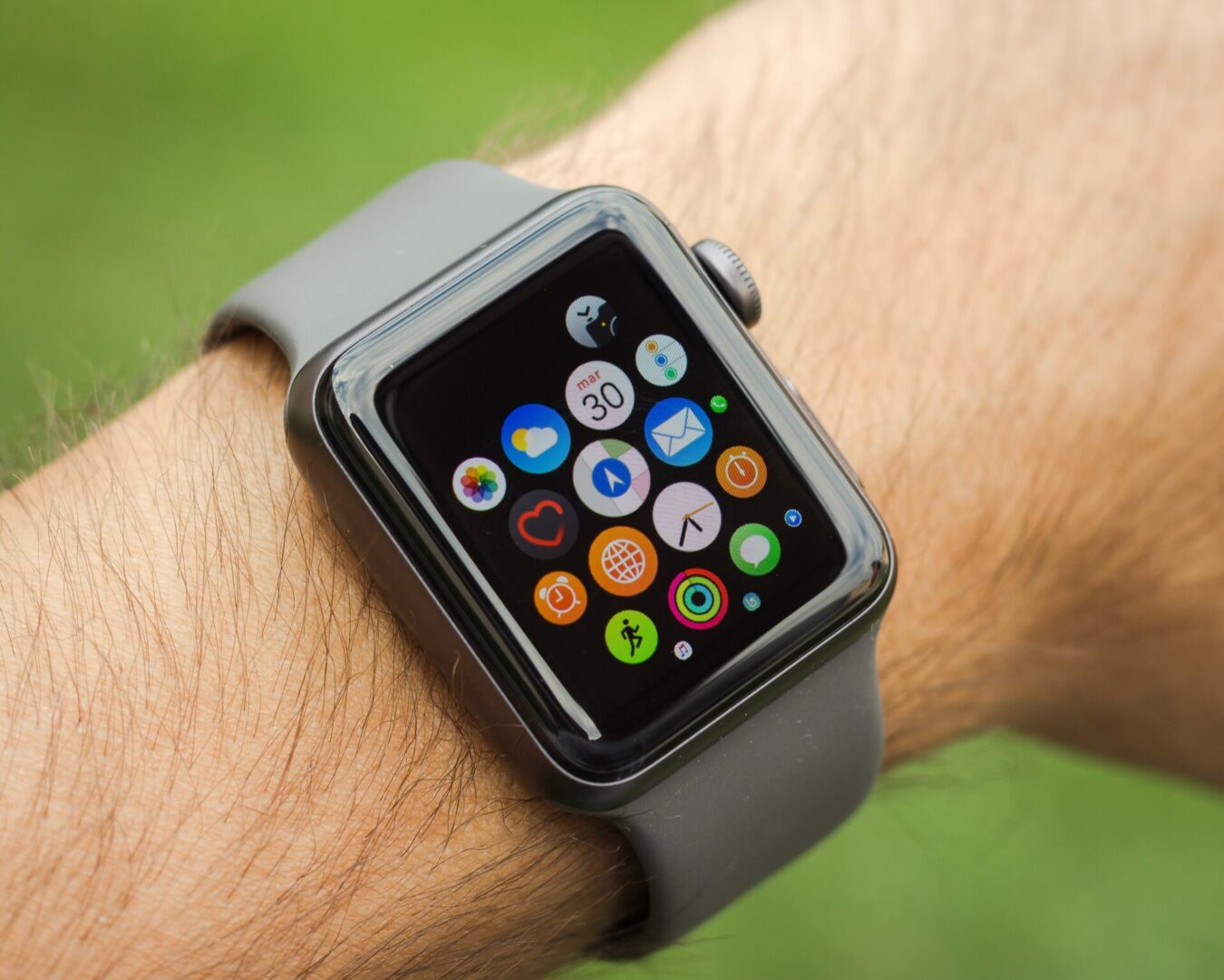 A person wearing an apple watch with various apps on it.
